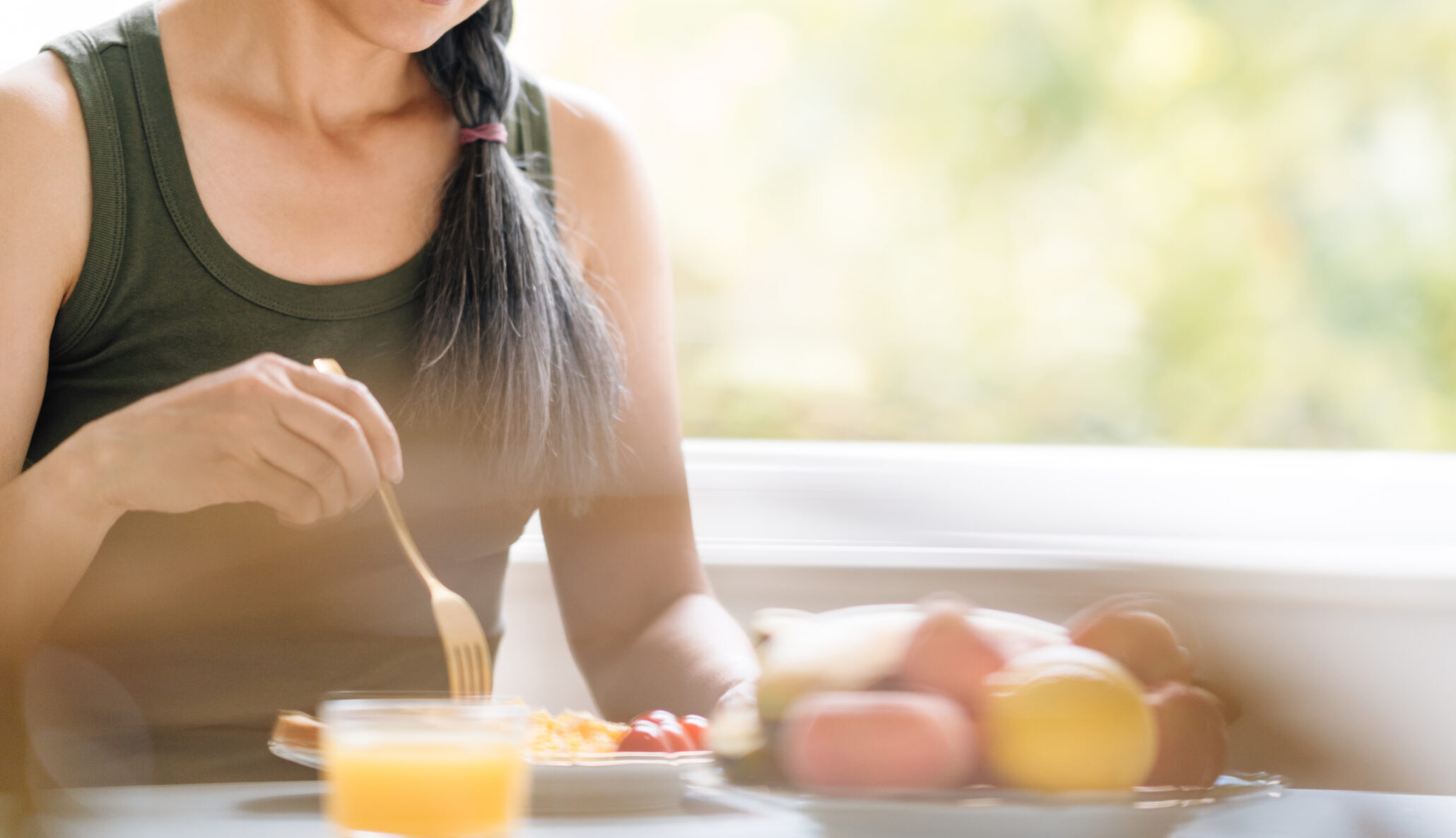 Mature asian woman with grey hair having breakfast at home Mature asian woman with grey hair having breakfast in morning at home