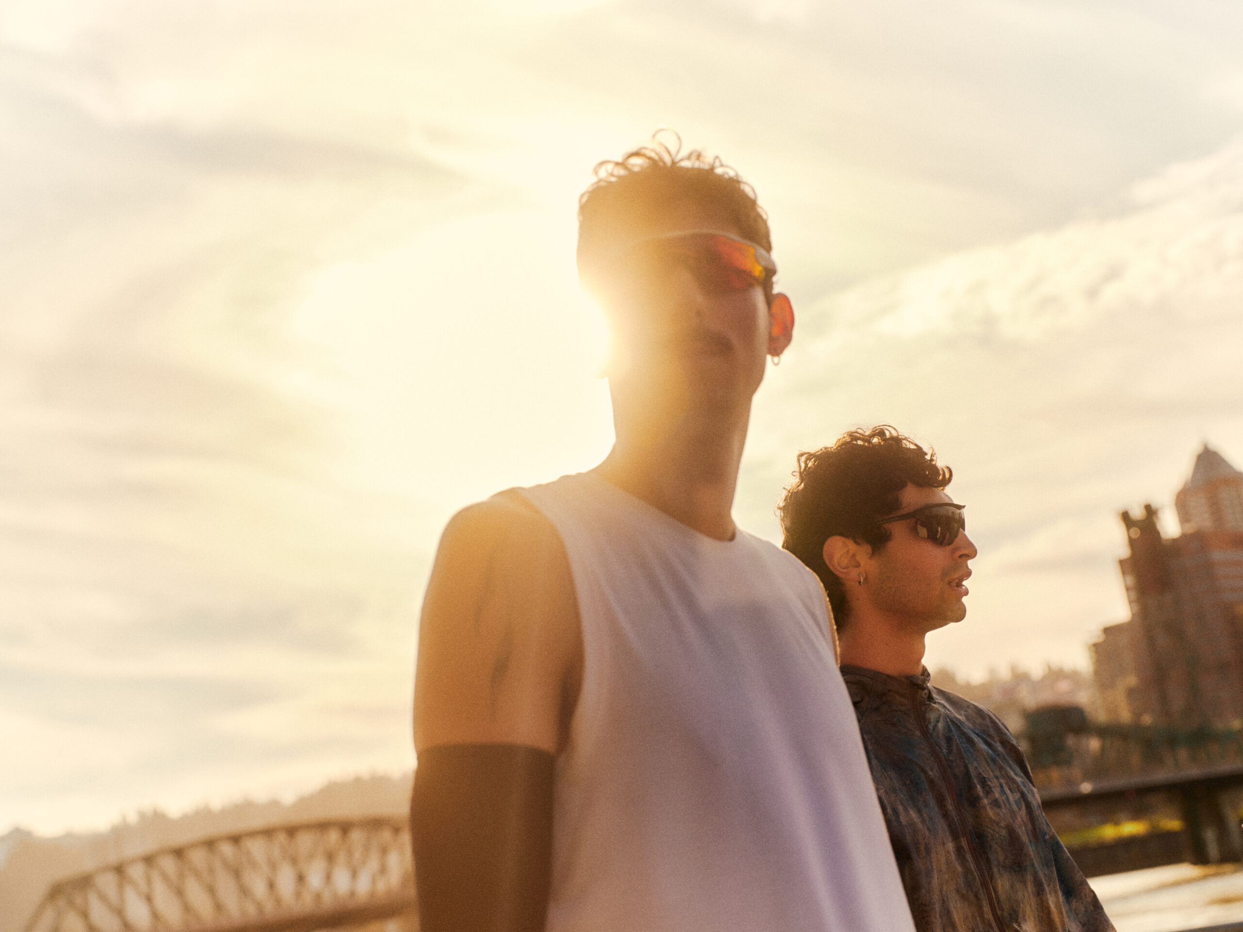 Sick man lying on the couch with high temperature and holding his throat with hand.
